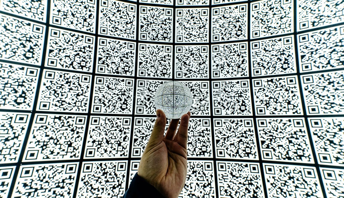 Hand met glazen bal op QR code achtergrond Hand met glazen bal op QR code achtergrond