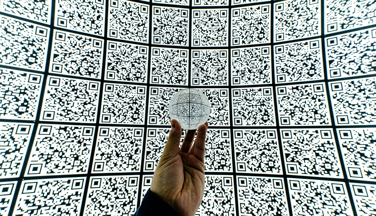 Hand met glazen bal op QR code achtergrond Hand met glazen bal op QR code achtergrond